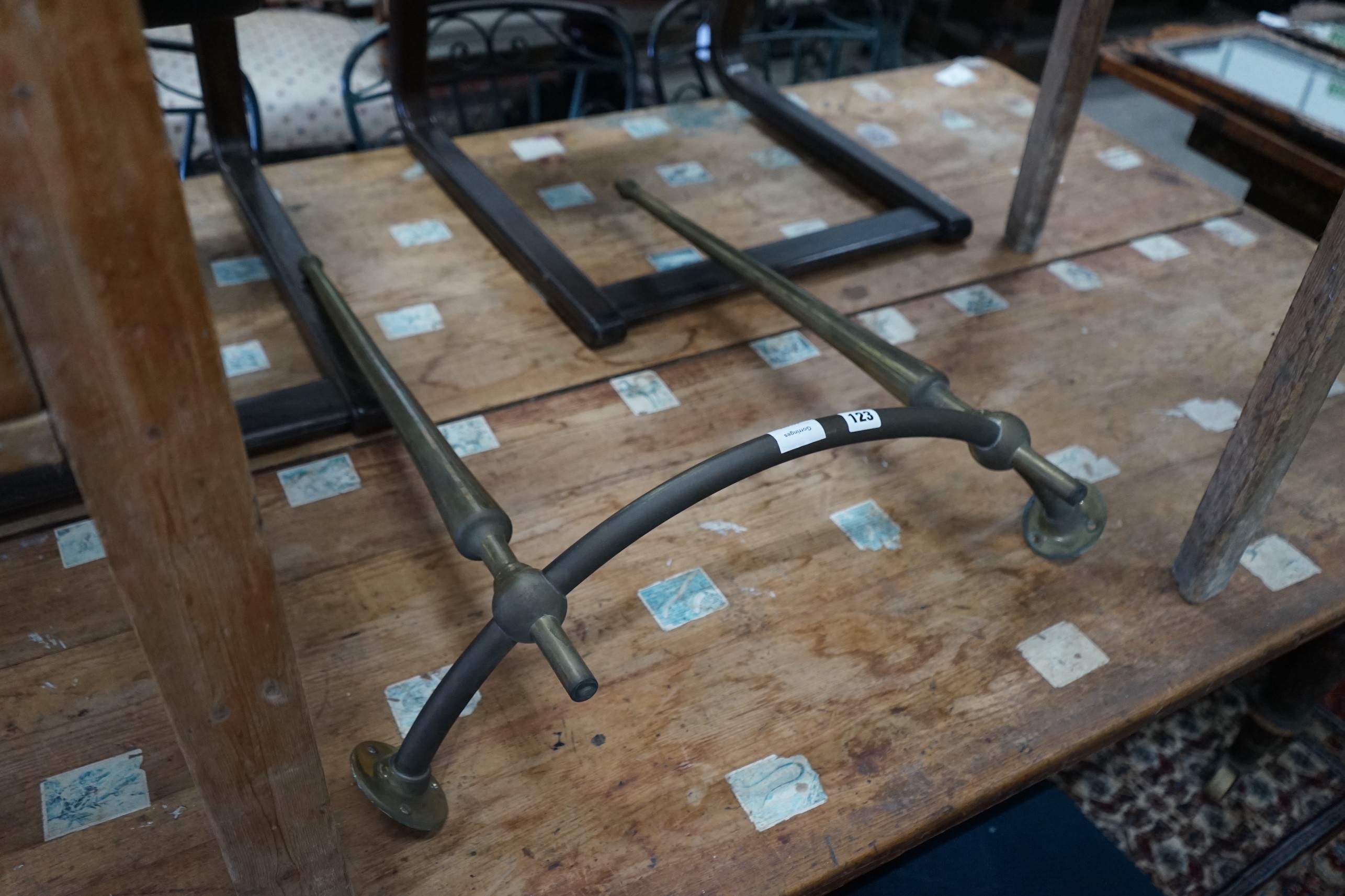 A bow front brass hanging rail, height 77cm